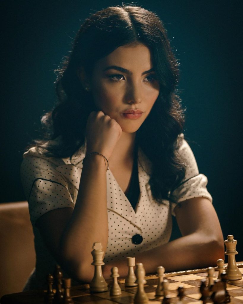 Andrea posing for picture while Playing Chess